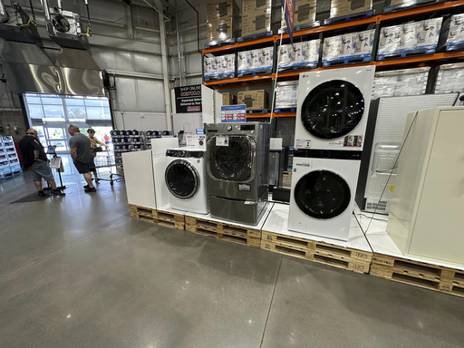 Washers stand on display near the entrance to a Costco warehouse Tuesday, July 8, 2025, in Sheridan, Colo. (AP Photo/David Zalubowski)