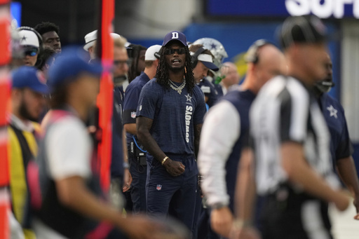 Dallas Cowboys wide receiver CeeDee Lamb, center, stands on the sidelines during the first half of an NFL preseason football game against the Los Angeles Rams, Saturday, Aug. 9, 2025, in Inglewood, Calif. (AP Photo/Mark J. Terrill)