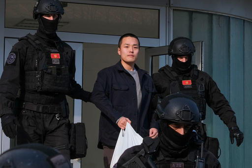 FILE - Montenegrin police officers escort South Korean citizen, Terraform Labs founder Do Kwon in Montenegro's capital Podgorica, March 23, 2024. (AP Photo/Risto Bozovic, File)