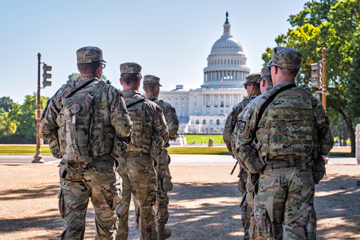 Armed National Guard soldiers from West Virginia patrol the Mall near the Capitol in Washington, as part of President Donald Trump's order to impose federal law enforcement in the District of Columbia, Tuesday, Aug. 26, 2025. (AP Photo/J. Scott Applewhite)