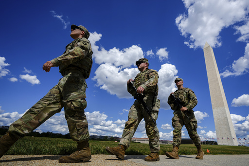 Armed South Carolina National Guardsmen patrol near the Washington Monument, Tuesday, Aug. 26, 2025, in Washington. (AP Photo/Julia Demaree Nikhinson)