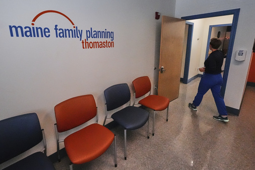 FILE - Vanessa Shields-Haas, a nurse practitioner, walks from the lobby toward the examination rooms at the Maine Family Planning healthcare facility, July 15, 2025, in Thomaston, Maine. (AP Photo/Charles Krupa)