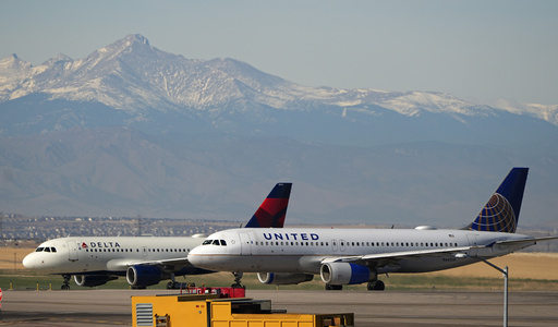 FILE- United and Delta Airlines jetliners taxi down a runway for take off at Denver International Airport, Dec. 24, 2024, in Denver. (AP Photo/David Zalubowski, File)