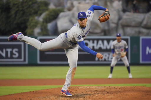 Los Angeles Dodgers starting pitcher Shohei Ohtani throws to the plate during the third inning of a baseball game against the Los Angeles Angels, Wednesday, Aug. 13, 2025, in Anaheim, Calif. (AP Photo/Mark J. Terrill)