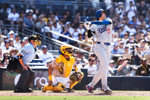 Los Angeles Dodgers' Shohei Ohtani hits a solo home run against the San Diego Padres in the ninth inning of a baseball game Sunday, Aug. 24, 2025, in San Diego. (AP Photo/Derrick Tuskan)