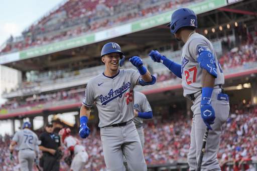 Los Angeles Dodgers' Tommy Edman (25) celebrates a two-run homer with Esteury Ruiz (27) during the second inning of a baseball game against the Cincinnati Reds, Tuesday, July 29, 2025, in Cincinnati. (AP Photo/Carolyn Kaster)