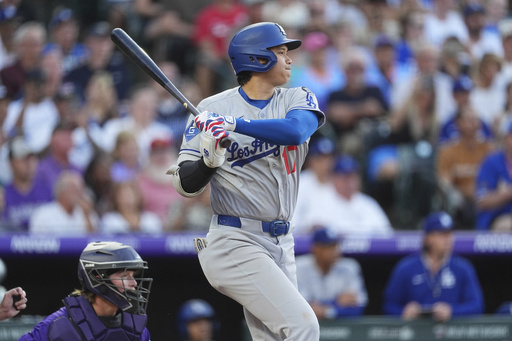 Los Angeles Dodgers' Shohei Ohtani follows the flight of his RBI single off Colorado Rockies starting pitcher Kyle Freeland in the second inning of a baseball game Monday, Aug. 18, 2025, in Denver. (AP Photo/David Zalubowski)