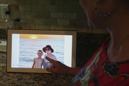 Julie Nicoll shows shows an undated photo with her grandson Xavier Thursday, April 24, 2025, in Naples, Fla. Julie and her husband have spent more than $20,000 in legal fees trying to get him released from a youth detention center. (AP Photo/Marta Lavandier)