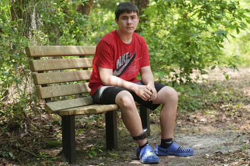 Cayden Gillespie sits on a bench at a local park Saturday, April 26, 2025, in Gainesville, Fla. Gillespie spent months in juvenile detention after pleading guilty to two felony charges. While in custody the state of Florida provided online learning instead of in person classes which students, parents and staff say has been disastrous. (AP Photo/Marta Lavandier)