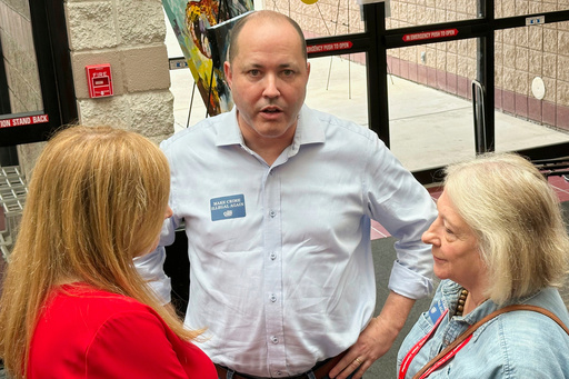 FILE - Georgia Attorney General Chris Carr, center, speaks to a delegate at the Georgia Republican Convention in Dalton, Ga., June 6, 2025. (AP Photo/Jeff Amy, File)