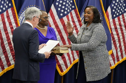 FILE - Lisa Cook, right, takes the oath of office to become a member of the Federal Reserve Board, May 23, 2022, in Washington. (AP Photo/Patrick Semansky, file)