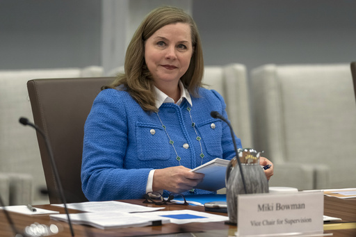 FILE - Michelle Bowman, Vice Chair for Supervision of the Federal Reserve Board of Governors, takes a seat for an open meeting of the Board of Governors at the Federal Reserve, in Washington, June 25, 2025. (AP Photo/Mark Schiefelbein, File)