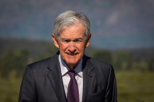 Federal Reserve Chairman Jerome Powell walks outside of Jackson Lake Lodge during a break at the Jackson Hole Economic Policy Symposium in Moran, Wyo., on Friday, Aug. 22, 2025. (AP Photo/Amber Baesler)
