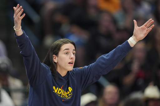 Indiana Fever guard Caitlin Clark reacts during the first half of a WNBA basketball game against the Dallas Wings Friday, Aug. 1, 2025, in Dallas. (AP Photo/Julio Cortez)