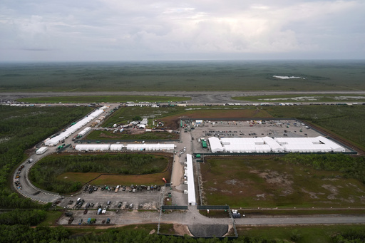 FILE - Work progresses on a new migrant detention facility dubbed "Alligator Alcatraz," at Dade-Collier Training and Transition facility in the Florida Everglades, on July 4, 2025, in Ochopee, Fla. (AP Photo/Rebecca Blackwell, File)