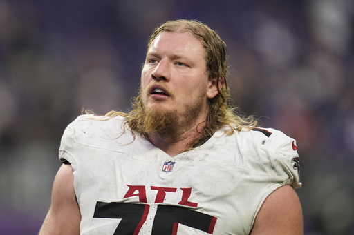 FILE - Atlanta Falcons offensive tackle Kaleb McGary (76) walks off the field after an NFL football game against the Minnesota Vikings, Sunday, Dec. 8, 2024, in Minneapolis. (AP Photo/Abbie Parr, file)
