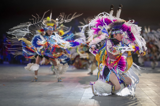 FILE - Thirteen year-old Leland Mitsuing, right, of Saskatchewan, Canada competes in the Jr. Boys Traditional competition at the 40th anniversary of the Gathering of Nations Pow Wow in Albuquerque, N.M., April 28, 2023. (AP Photo/Roberto E. Rosales, File)