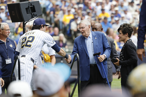 Bud Selig, second right, greets Milwaukee Brewers' Christian Yelich before the Bob Uecker Celebration of Life ceremony before a baseball game between the San Francisco Giants and the Milwaukee Brewers, Sunday, Aug. 24, 2025, in Milwaukee. (AP Photo/Jeffrey Phelps)