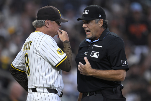 San Diego Padres manager Mike Shildt, left, talks to home plate umpire James Hoye, right, after being ejected during the second inning of a baseball game against the San Francisco Giants, Monday, Aug 18, 2025, in San Diego. (AP Photo/Orlando Ramirez)