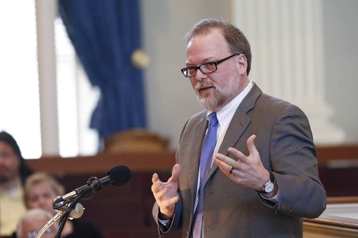 FILE - New York Times best-selling author Greg Iles of Natchez, Miss., states the need for a change of the Mississippi state flag during the seventh annual Statehood Day celebration Thursday, Dec. 10, 2015, in Jackson, Miss. (AP Photo/Rogelio V. Solis, File)