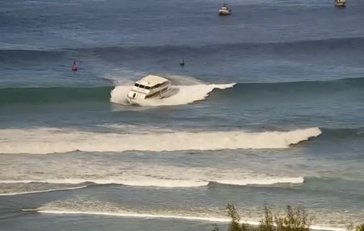 This still image from video and provided by the U.S. Coast Guard shows a 75-foot passenger vessel running aground near Kewalo Basin Harbor, Honolulu, on Saturday, Aug. 9, 2025. (U.S. Coast Guard via AP)