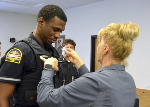 FILE - In this undated photo provided by Old Orchard Beach Police Department, Officer Jon Luke Evans receives his police badge. (Old Orchard Beach Police Department via AP, File)