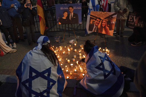 FILE - People gather to light candles in a makeshift memorial to honor Yaron Lischinsky and Sarah Milgrim who were killed as they left an event at the Capital Jewish Museum in Washington, during a candlelight vigil outside of the White House in Washington, Thursday, May 22, 2025. (AP Photo/Jose Luis Magana, File)