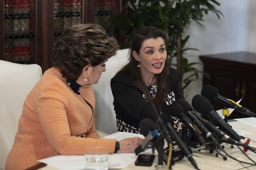 Alicia Arden, who accused Jeffrey Epstein of sexual battery in 1997, reads a statement alongside her attorney, Gloria Allred, during a news conference in Los Angeles Wednesday, Aug. 6, 2025. (AP Photo/Jae C. Hong)