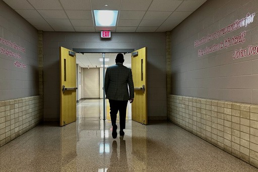 Chief of Talent at New Schools for New Orleans, Jahquille Ross, walks down a hallway at Alice Hart Charter School in New Orleans, on July 30, 2025. (AP Photo/Stephen Smith)