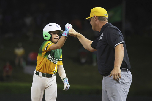Sioux Falls, S.D.'s Bohde Larson, left, celebrates his hit against Bonney Lake, Wash., during the sixth inning of a baseball game at the Little League World Series, Tuesday, Aug. 19, 2025, in South Williamsport, Pa. (AP Photo/Jared Freed)