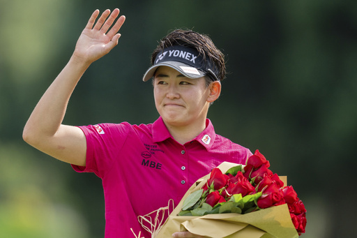 Akie Iwai, of Japan, waves towards the crowd after winning the LPGA Portland Classic golf tournament at Columbia Edgewater in Portland, Ore., Sunday, Aug. 17, 2025. (AP Photo/Ali Gradischer)