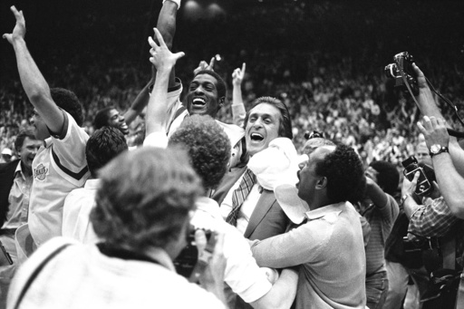 FILE - Los Angeles Lakers head coach Pat Riley, center right, is swamped by fans and players after the Lakers defeated the Philadelphia 76ers to win the NBA championship in Los Angeles, June 9, 1982. (AP Photo/Lennox McLendon, File)