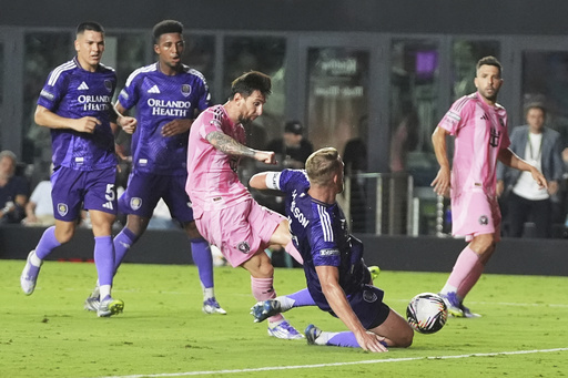 Inter Miami forward Lionel Messi, third from left, scores a goal as Orlando City defender Robin Jansson, second from right, defends during the second half of a Leagues Cup semifinal soccer match, Wednesday, Aug. 27, 2025, in Fort Lauderdale, Fla. (AP Photo/Lynne Sladky)