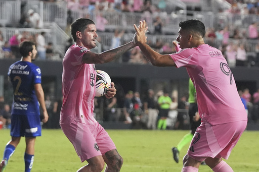 Inter Miami midfielder Rodrigo De Paul, left celebrates with forward Luis Suárez (9) after scoring a goal during the first half of a Leagues Cup soccer match against Puma UNAM, Wednesday, Aug. 6, 2025, in Fort Lauderdale, Fla. (AP Photo/Lynne Sladky)