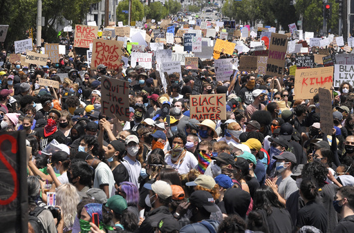 FILE - Demonstrators sit in an intersection during a protest over the death of George Floyd, on May 30, 2020, in Los Angeles. (AP Photo/Mark J. Terrill, File)