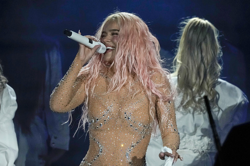 FILE - Karol G performs at Azteca Stadium in Mexico City on Feb. 8, 2024. (AP Photo/Eduardo Verdugo, File)
