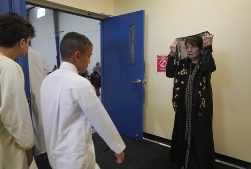 Fatima Igram Smejkal, whose family immigrated to the United States from Lebanon in the early 1900s, greets fellow faithful before Friday prayer at the Islamic Center of Cedar Rapids on Friday, Aug. 8, 2025, in Cedar Rapids, Iowa. (AP Photo/Jessie Wardarski)