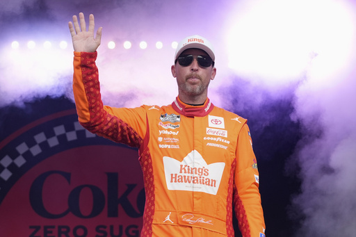 Denny Hamlin waves to fans during driver introductions before the NASCAR Cup Series auto race at Daytona International Speedway, Aug. 23, 2025, in Daytona Beach, Fla. (AP Photo/John Raoux)