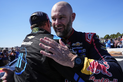 Shane van Gisbergen, right, celebrates with a crew member after winning a NASCAR Cup Series auto race at Sonoma Raceway, Sunday, July 13, 2025, in Sonoma, Calif. (AP Photo/Godofredo A. Vásquez)
