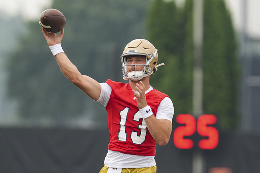 FILE - Notre Dame quarterback CJ Carr throws during NCAA college football practice in South Bend, Ind., July 31, 2025. (AP Photo/Michael Conroy, file)