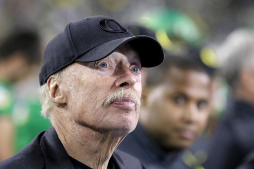 FILE - In this Sept. 26, 2015, file photo, Nike co-founder Phil Knight watches from the sidelines during the second half of an NCAA college football game between Oregon and Utah in Eugene, Ore. (AP Photo/Ryan Kang, File)