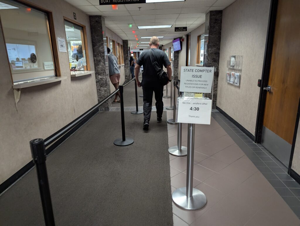 A man approaches the Minnehaha County Treasurer's Office in Sioux Falls on Aug. 20, 2025, the second day on which a power outage shut down access to state records. (John Hult/South Dakota Searchlight)