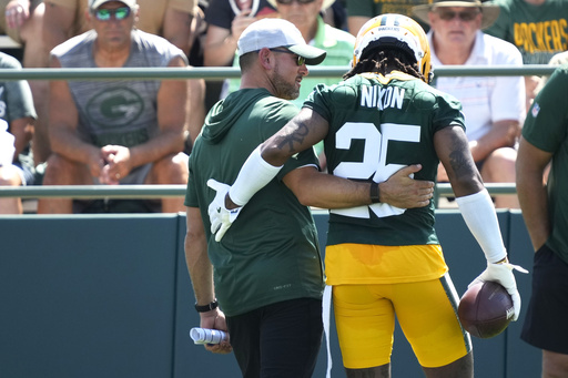Green Bay Packers Head Coach Matt LaFleur, left, talks with Keisean Nixon (25) during an NFL football practice Sunday, July 27, 2025, in Green Bay, Wis. (AP Photo/Kayla Wolf)