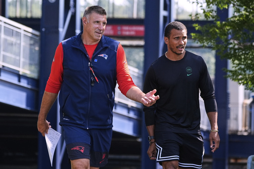 New England Patriots head coach Mike Vrabel, left, chats with Boston Celtics head coach Joe Mazzulla at the football team's NFL training camp, Wednesday, July 30, 2025, in Foxborough, Mass. (AP Photo/Charles Krupa)