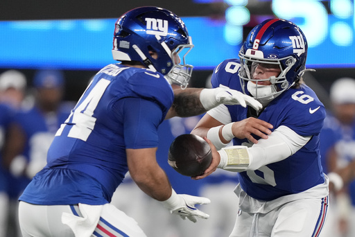 New York Giants quarterback Jaxson Dart (6) hands off the ball to running back Cam Skattebo (44) during the first quarter of an NFL football game, Thursday, Aug. 21, 2025, in East Rutherford, N.J. (AP Photo/Frank Franklin II)
