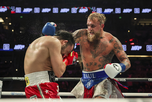 FILE - Jake Paul, right, throws a punch at Julio Cesar Chavez Jr. during their cruiserweight boxing match on June 28, 2025, in Anaheim, Calif. (AP Photo/Etienne Laurent, File)