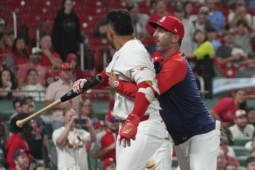 St. Louis Cardinals' Willson Contreras, left, is held back by Cardinals bench coach Daniel Descalso after being ejected during the seventh inning of a baseball game against the Pittsburgh Pirates Monday, Aug. 25, 2025, in St. Louis. (AP Photo/Jeff Roberson)