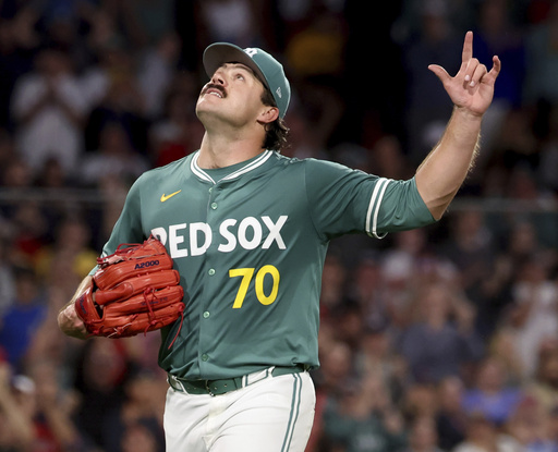 Boston Red Sox pitcher Payton Tolle gestures to the sky while walking to the dugout after being pulled during the sixth inning of a baseball game against the Pittsburgh Pirates, Friday, Aug. 29, 2025, in Boston. (AP Photo/Mark Stockwell)
