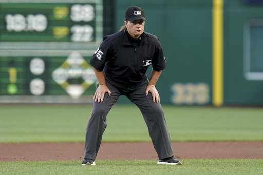 Umpire Jen Pawol watches during the first inning of a baseball game between the Colorado Rockies and the Pittsburgh Pirates, Friday, Aug. 22, 2025, in Pittsburgh. (AP Photo/Matt Freed)