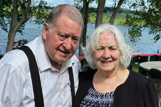 Gene and Christine Corrigan stand outside their restaurant, The Lake House Restaurant & Lodge, in Richfield Springs, N.Y., on Friday, July 18, 2025. (AP Photo/Michael Hill)